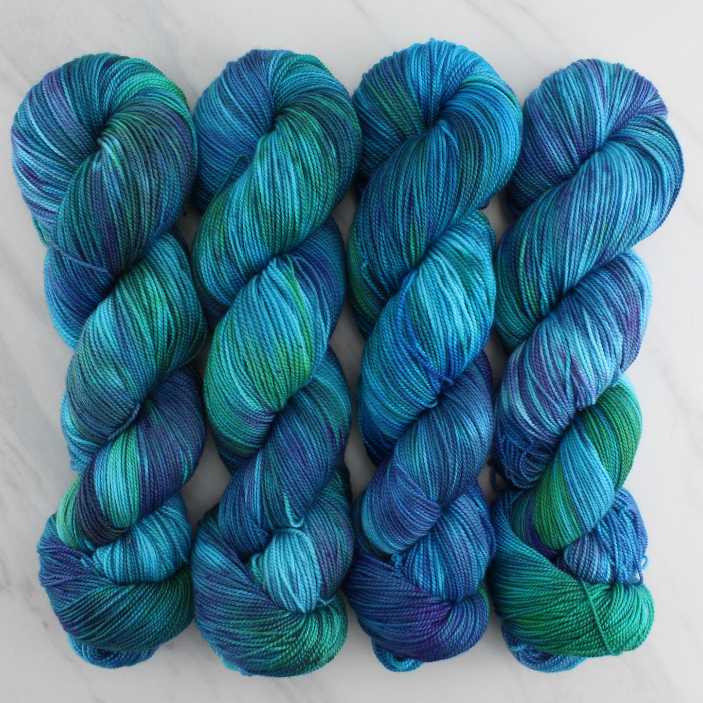 DREAMS OF THE SEA Hand Dyed on Feather Fingering - Splashed & Speckled Yarn